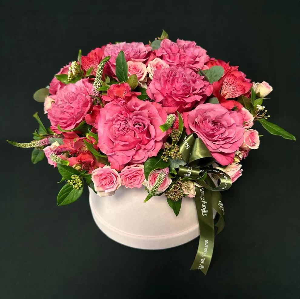 Valentine's Day bright pink rose box featuring a stunning array of roses and green accents, a passionate expression of affection.