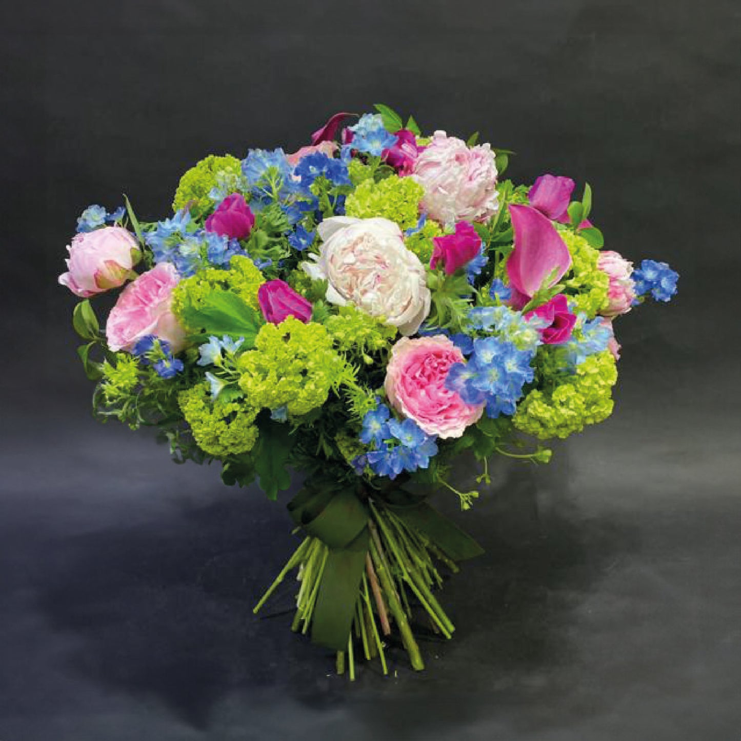 A colourful bouquet featuring a mix of roses and other vibrant flowers for a festive occasion.