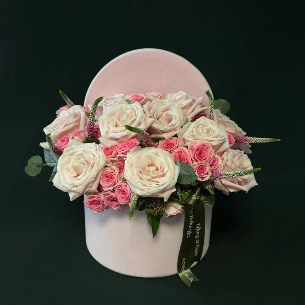 Valentine's Day white and pink rose round box with a blend of soft roses and vibrant green foliage, ideal for expressing love.